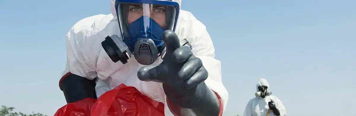 sewage clean up technician wearing protective gear handling biohazard materials in Sacramento, CA