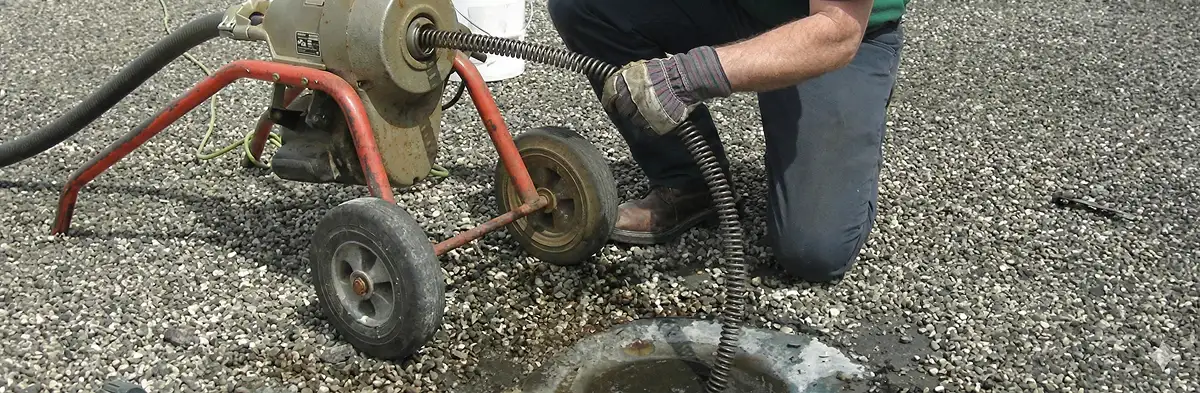 sewer rodding technician actively removing blockages from a sewer line in Sacramento, CA